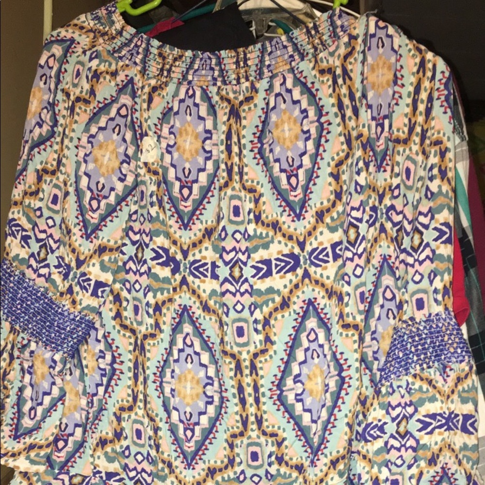 Off the shoulder multi color shirt.